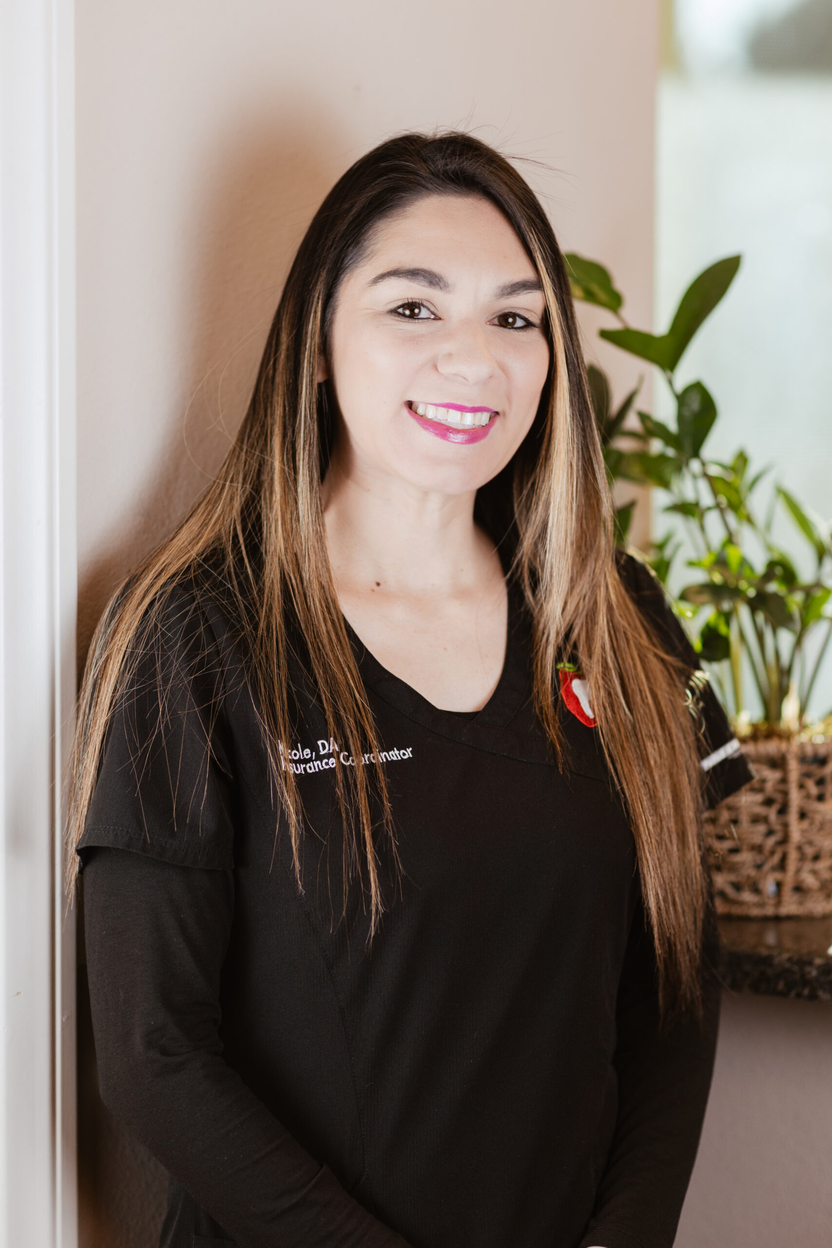 Headshot of Nicole, Dental Insurance Coordinator at Centerpoint Dental in Yucaipa, CA, wearing black scrubs and smiling warmly