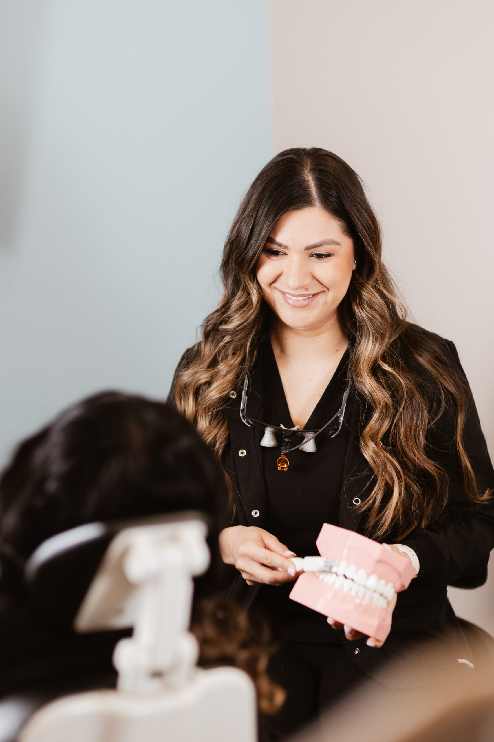 Female dental hygienist at Centerpoint Dental in Yucaipa demonstrating proper brushing technique using a dental model