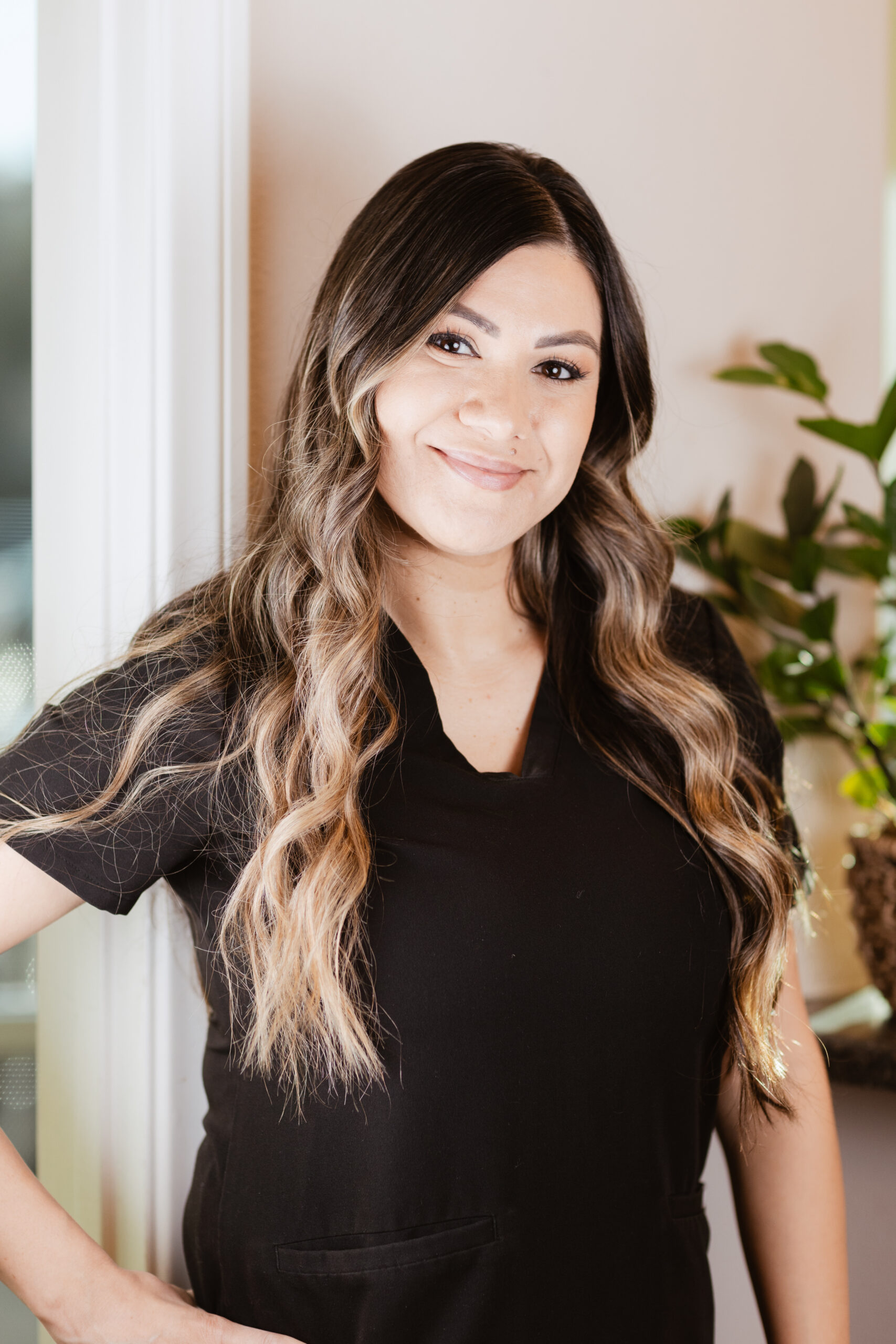 Headshot of Cecilly, Registered Dental Hygienist at Centerpoint Dental in Yucaipa, CA, smiling and wearing black scrubs